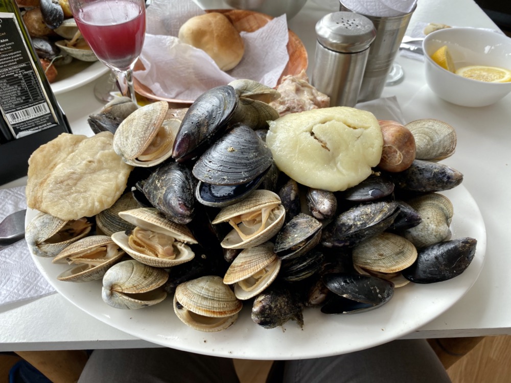 Traditionally cooked meal of mussels, clams, and meat